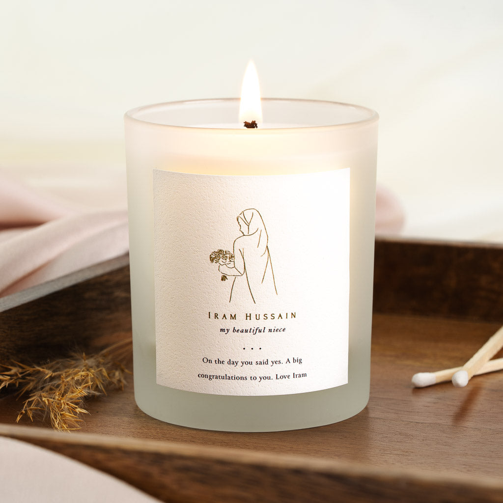 Bridal bouquet illustration above three small dots on a personalised wedding candle