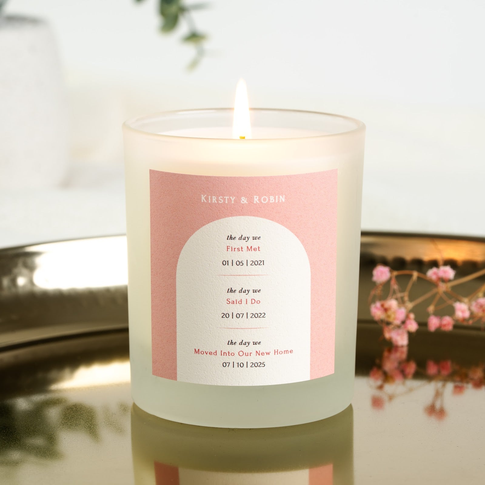 Personalised anniversary candle with each milestone set on its own line inside an arch