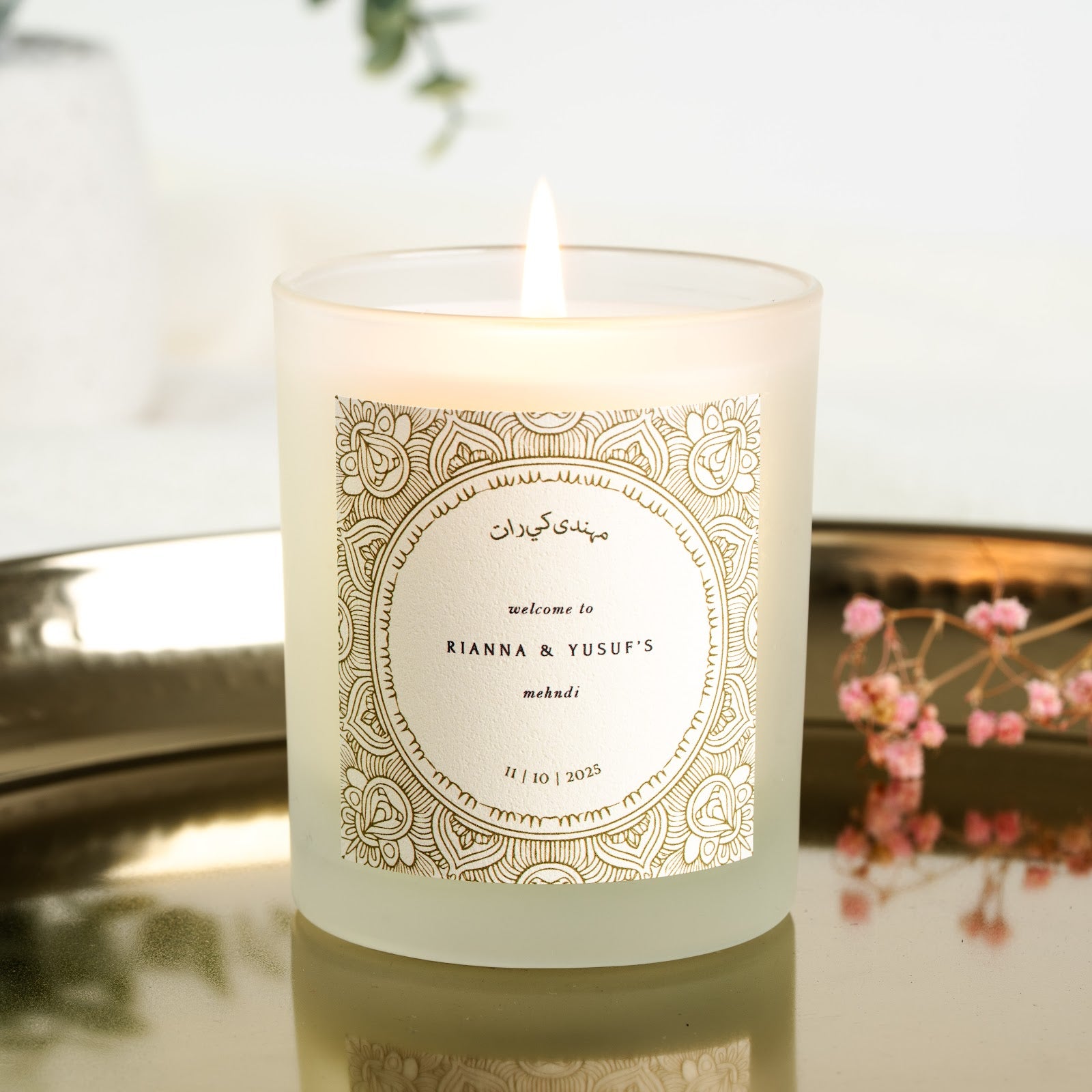 Gold-toned mandala pattern framing a circular panel on a personalised mehndi candle label