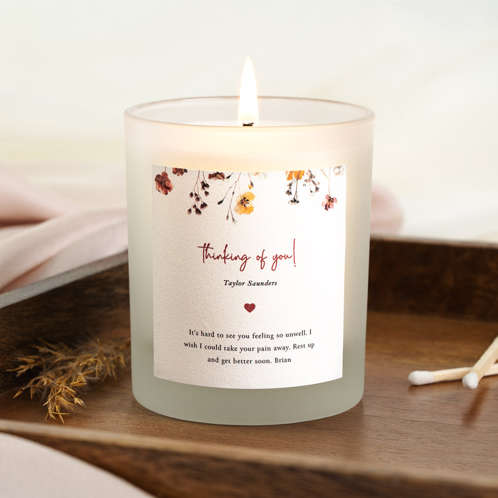 Personalised get well candle with trailing red and gold flowers above red script