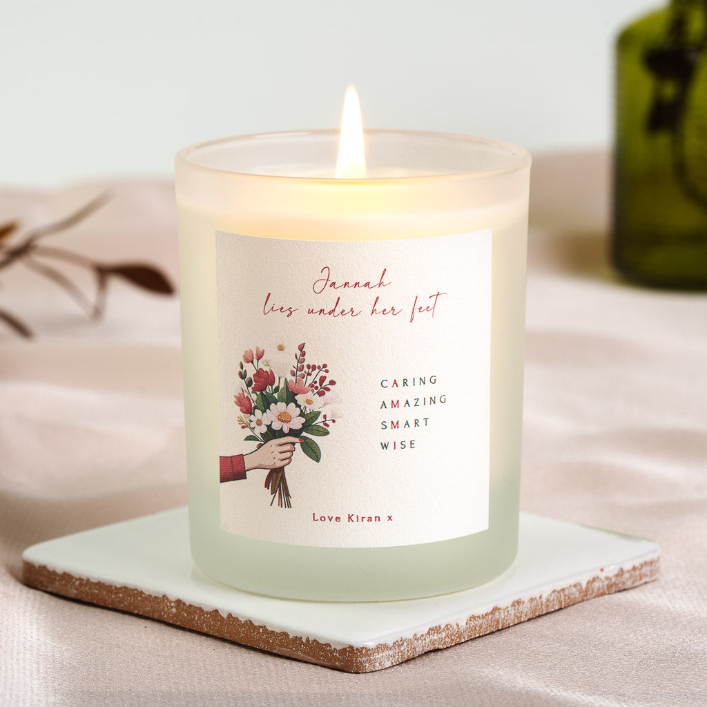 Hand holding a bouquet of red and white flowers on a personalised Islamic new mum candle
