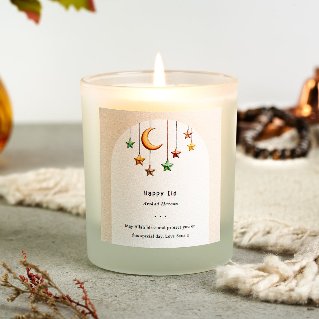 Personalised Eid candle with hanging stars and a crescent moon inside a watercolour arch