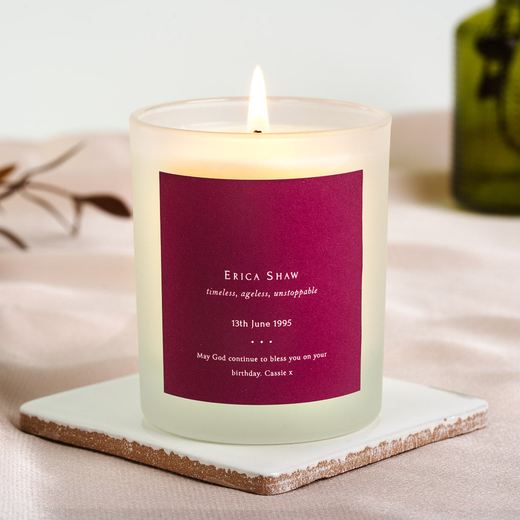 Solid berry panel with the name above an italic tagline on a personalised birthday candle