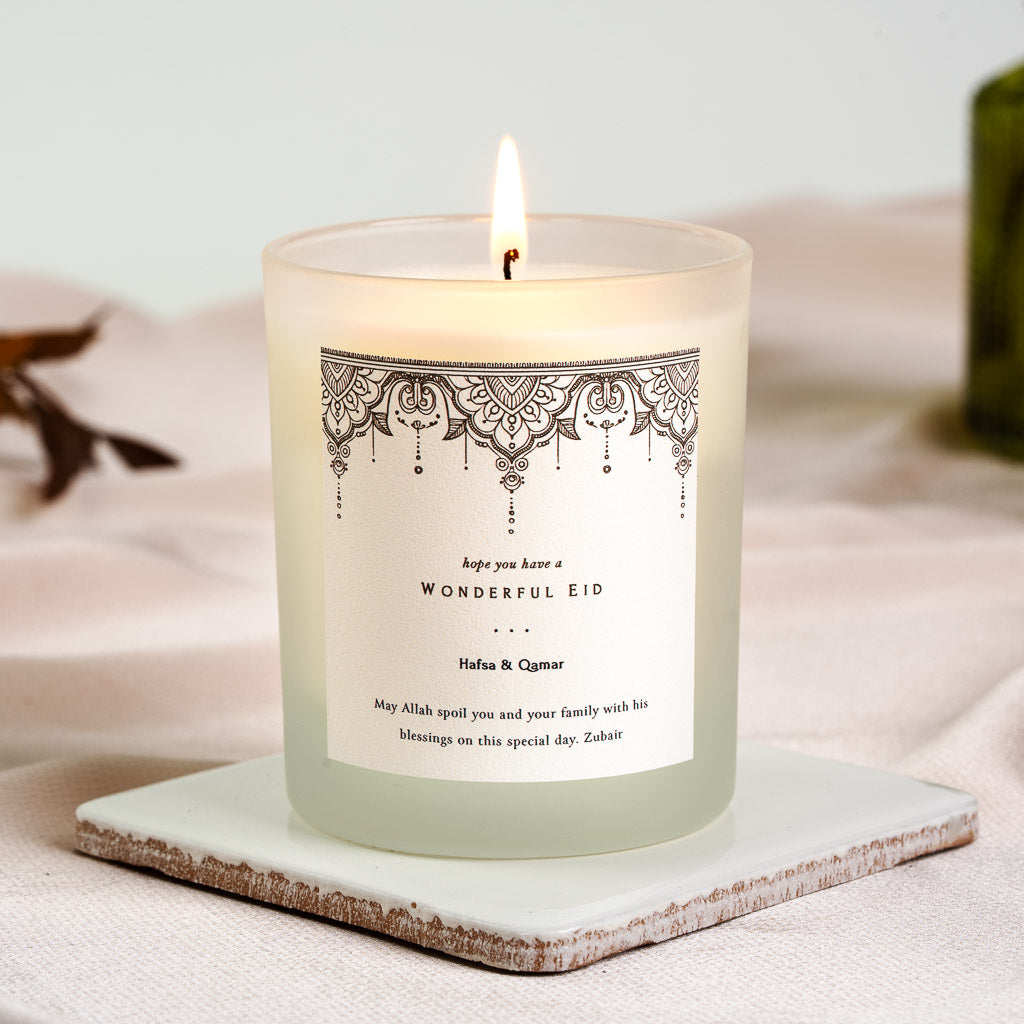 Mandala-style lace pattern in black ink across a personalised Eid candle label