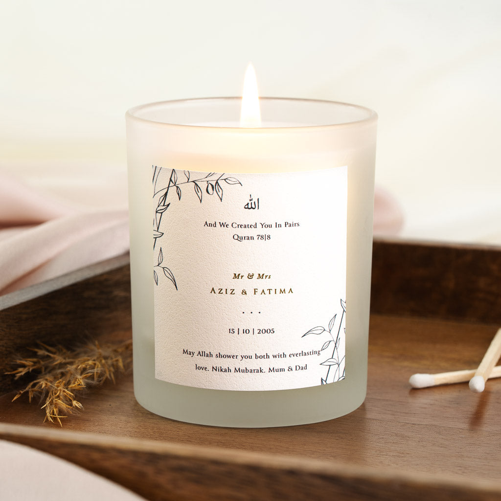Fine line leafy vines framing Arabic calligraphy on a personalised nikah candle label